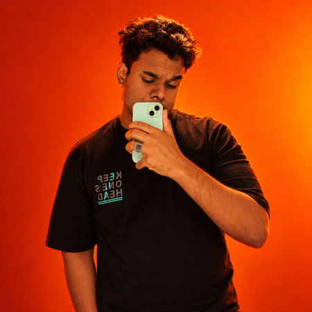 Mirror selfie against a vivid orange gradient